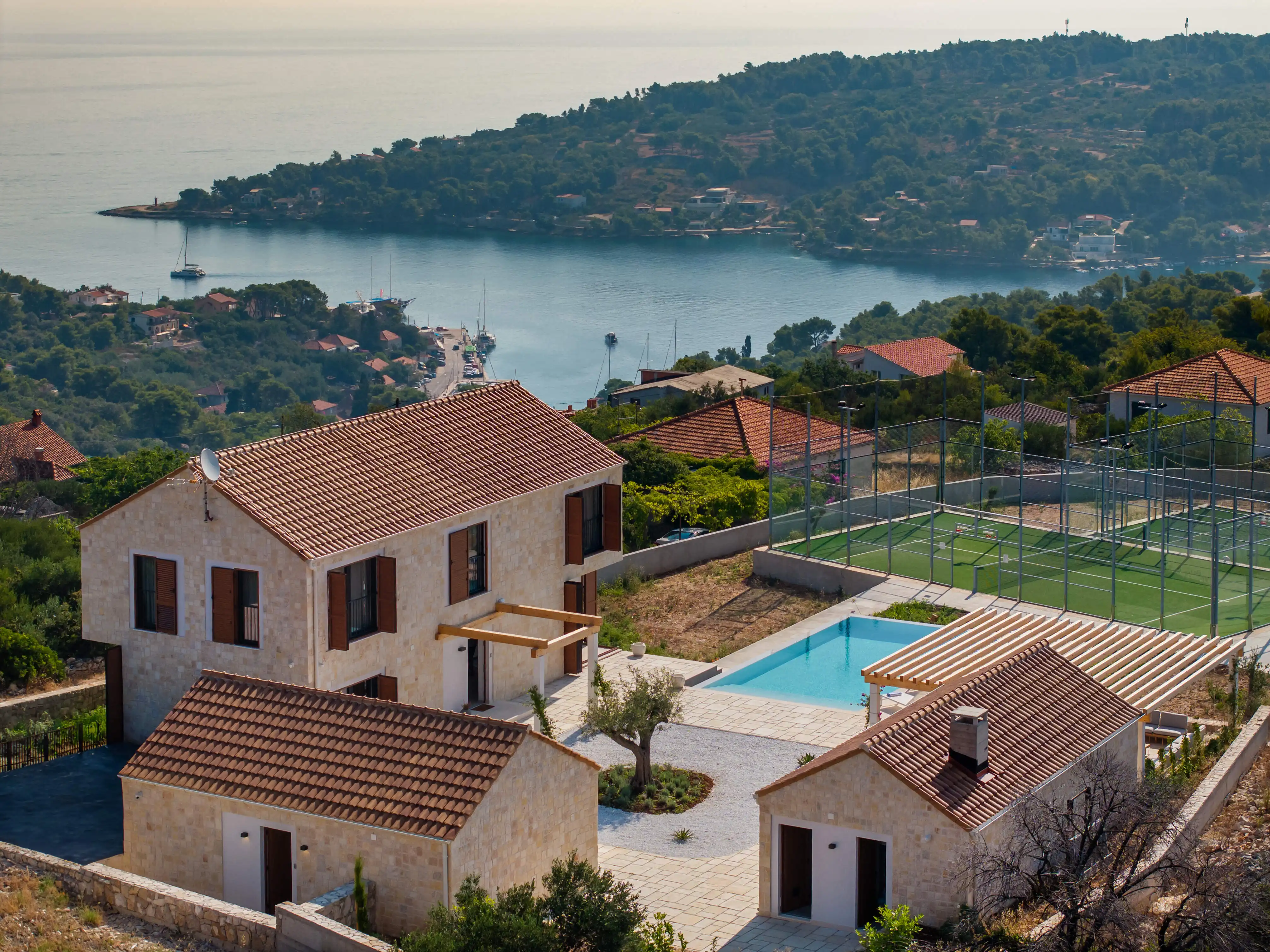 Luxury villa with a padel court and pool overlooking the sea