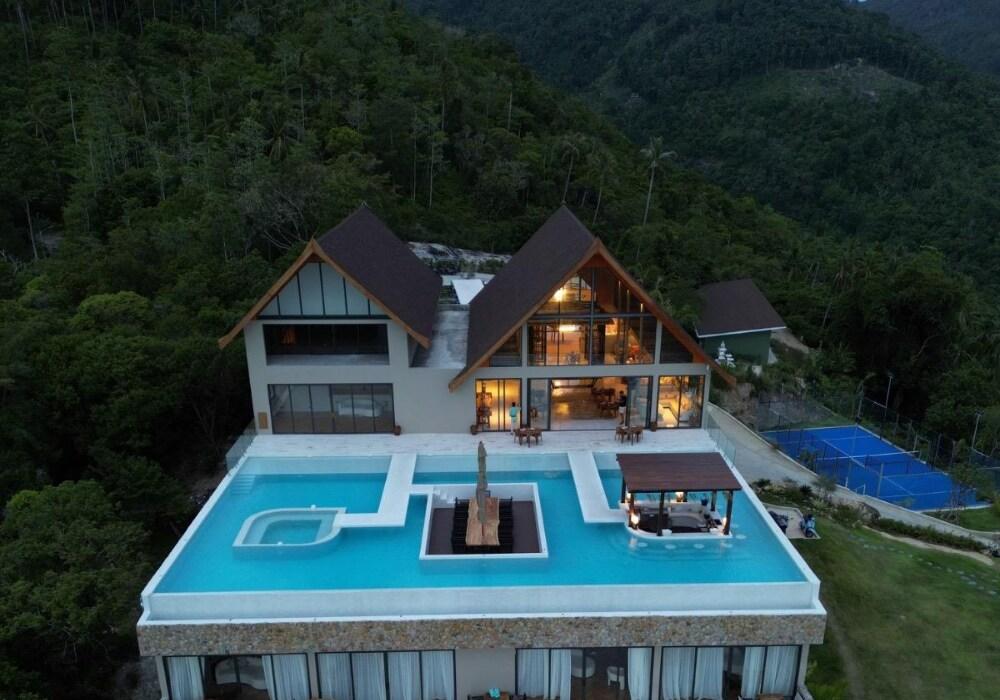 A hillside villa with a large infinity pool and mountain views at Ida B Domain in Koh Samui, Thailand, with a padel court nearby