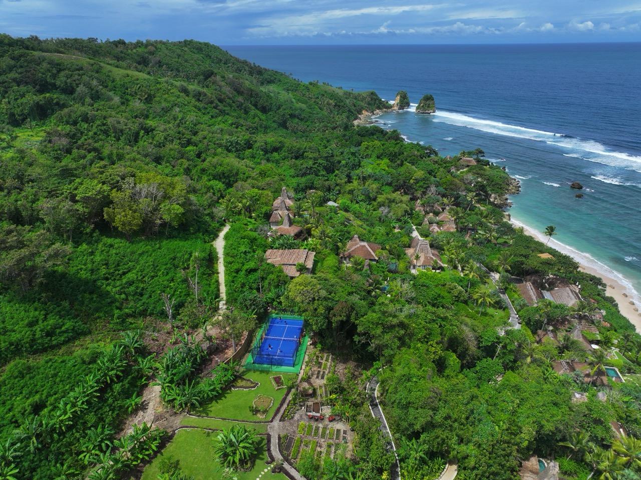 Padel court at NIHI Sumba resort in Indonesia with ocean view.