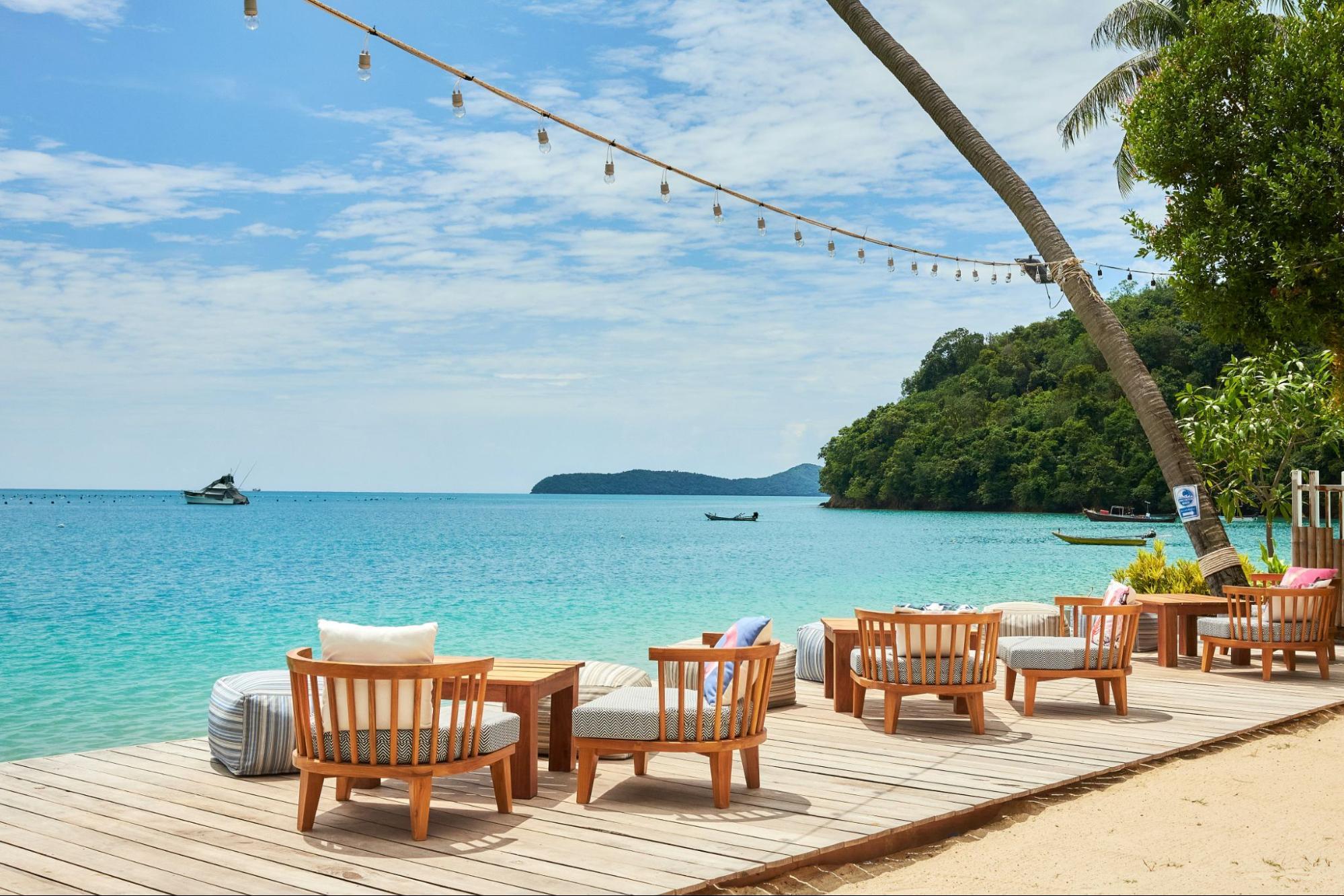 Beachfront lounge deck overlooking turquoise water Phuket, Thailand